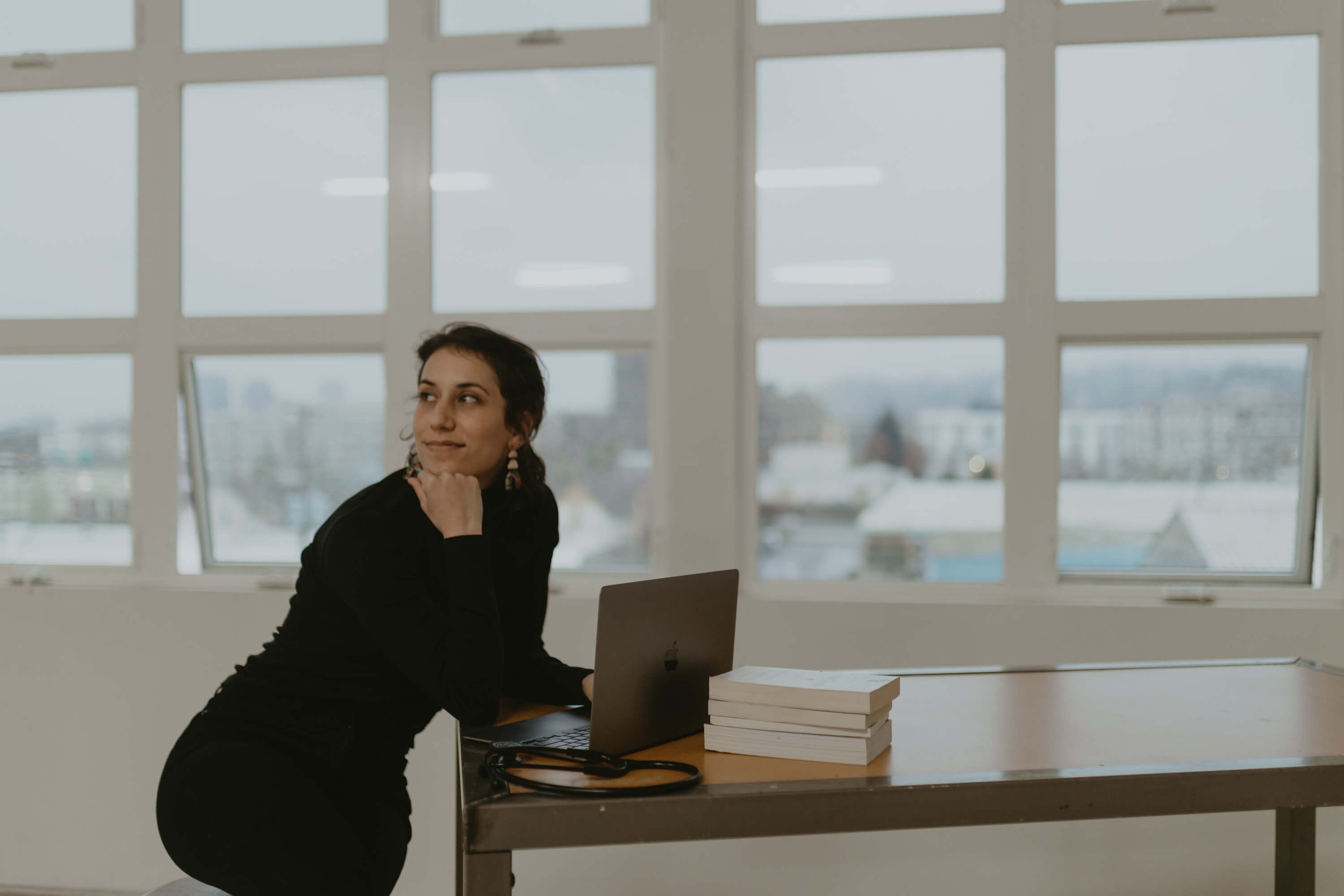 Bridget, Founder of Sleep-Deprived Nurse, sitting at a desk and celebrating her first year in business