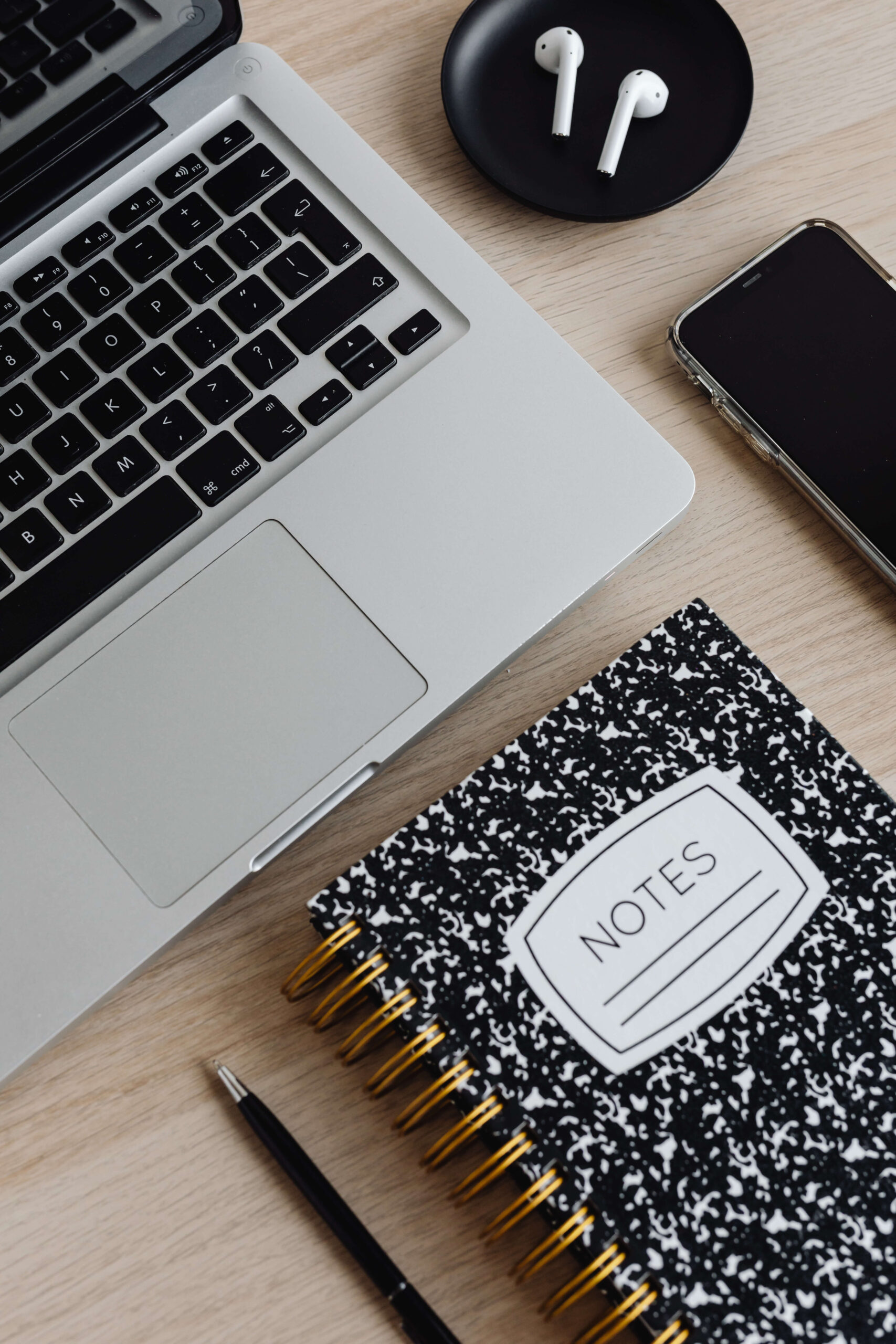 nurse blogger's laptop, airpods, notebook, and phone - image from kaboompics